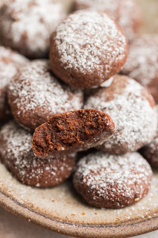 Close-up view of keto chocolate cookies in a beige bowl with powdered monk fruit sweetener