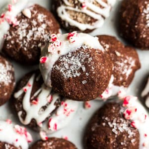 Close up view of keto chocolate peppermint cookies stacked on a white plate