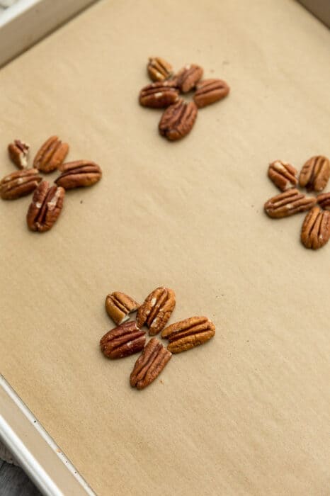 Top view of pecan clusters on parchment paper