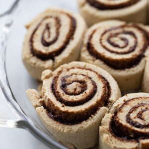 Close-up of raw cinnamon rolls in a glass pie dish