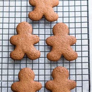Top view of 4 plain gingerbread men cookies on a cooling rack