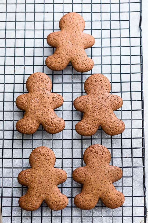 Top view of undecorated gingerbread man cookies on a cooling rack