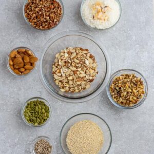 Top view of ingredients to make healthy granola on a grey background