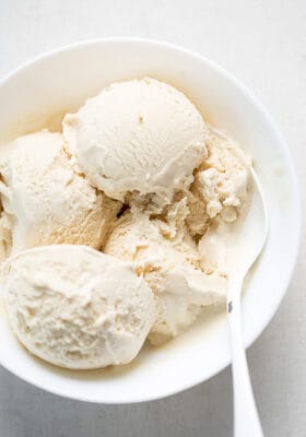 Top view of 4 scoops of low carb keto ice cream in a white bowl with a spoon
