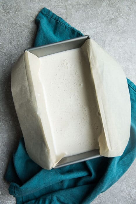 Top view of unfrozen Low Carb Keto Ice Cream in a loaf pan lined with parchment paper