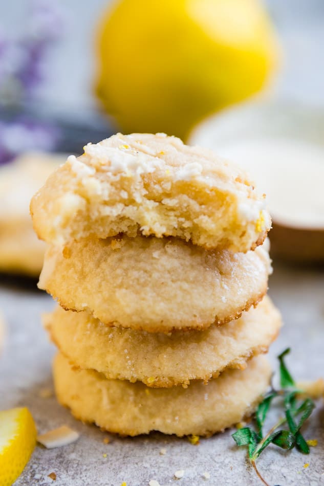 Side view of stacked keto low carb lemon cookies with a bite