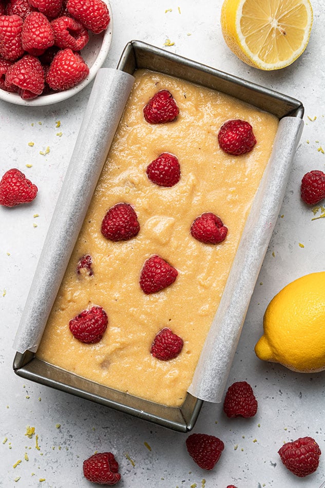 Overhead view of raspberry lemon loaf in a pan before baking
