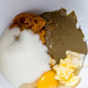 Top view of wet ingredients in a white bowl to make keto pumpkin pie