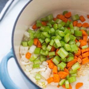 Sautéed onions, garlic, celery and carrots in a blue pot