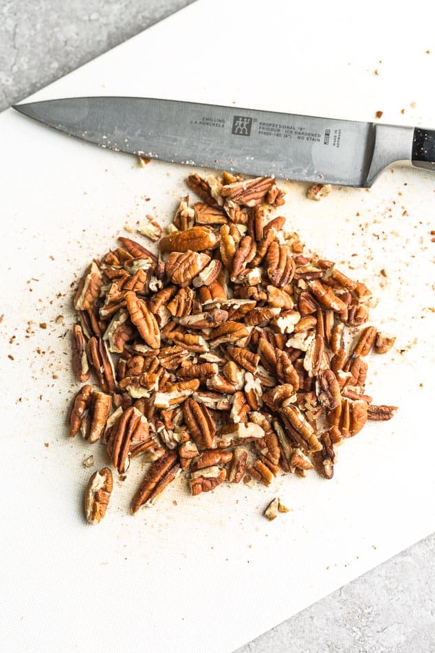 Chopped pecans with a knife