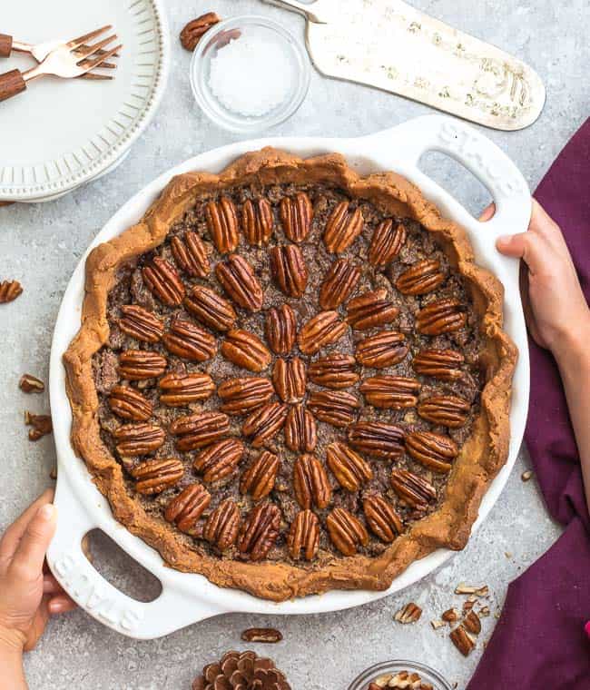 Top view with hands holding the pan with Keto Pecan Pie