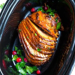 Low carb glazed 8 lb spiral cut ham in a black 6 quart oval slow cooker