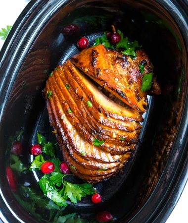 Low carb glazed 8 lb spiral cut ham in a black 6 quart oval slow cooker