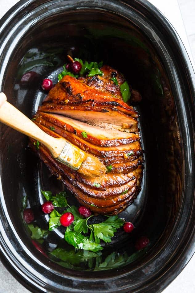 Low carb glazed 8 lb spiral cut ham in a black 6 quart oval slow cooker