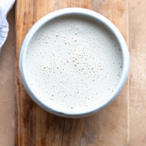 Top view of cashew cream on a wooden cutting board