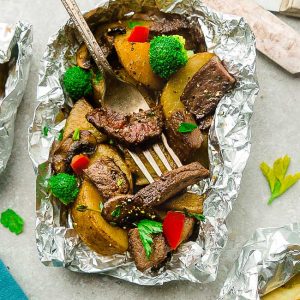 Teriyaki Beef Foil Packets - made with tender steak, broccoli, bell peppers, mushrooms and potatoes tossed in a sweet and savory Asian-inspired sauce. These bake up perfectly in the oven on a busy weeknight - or toss them on the grill for a weekend summer cookout.