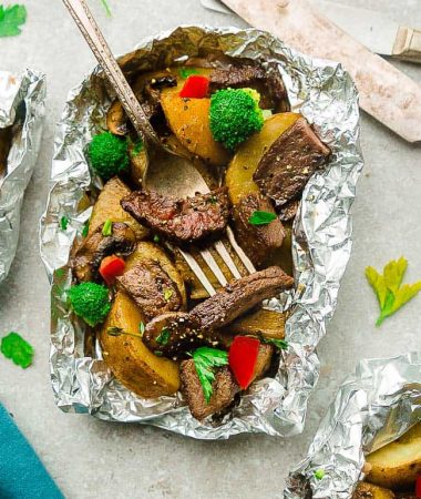 Teriyaki Beef Foil Packets - made with tender steak, broccoli, bell peppers, mushrooms and potatoes tossed in a sweet and savory Asian-inspired sauce. These bake up perfectly in the oven on a busy weeknight - or toss them on the grill for a weekend summer cookout.