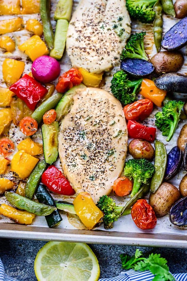 Close-up of Lemon Herb Chicken with Rainbow Vegetables on a sheet pan
