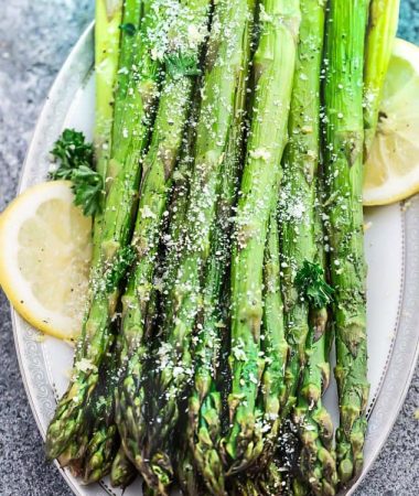 Lemon Parmesan Roasted Asparagus is the perfect quick and easy side dish for holidays or any night of the week. Best of all, this recipe only requires 5 minutes of prep with fresh lemon juice, garlic and Parmesan.