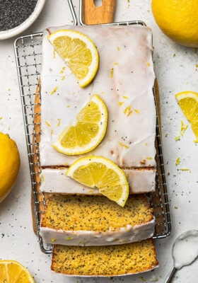 Flat lay of a lemon loaf with two slices on a wire rack
