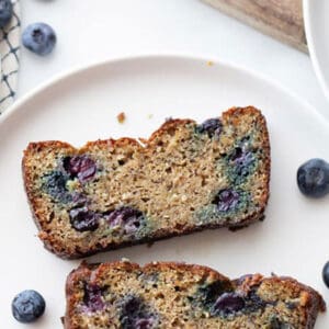 Pinterest graphic of two slices of blueberry banana bread on white plate.