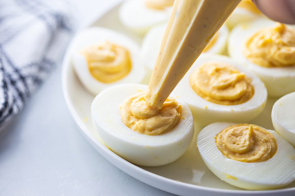 A piping bag filling deviled eggs