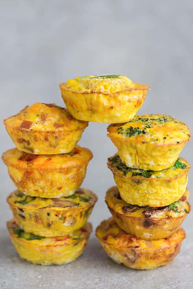 9 Different Flavors of Breakfast Egg Muffins Stacked on top of each other 