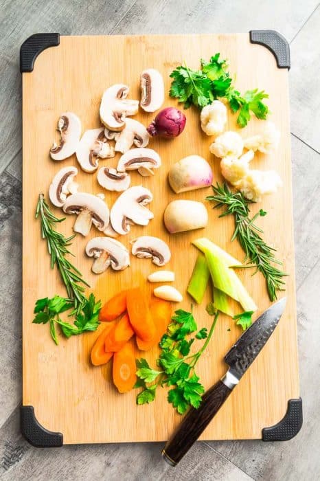 Chopped Mushrooms, Carrots, Celery and the Rest of the Pot Roast Veggies on a Cutting Board with a Knife