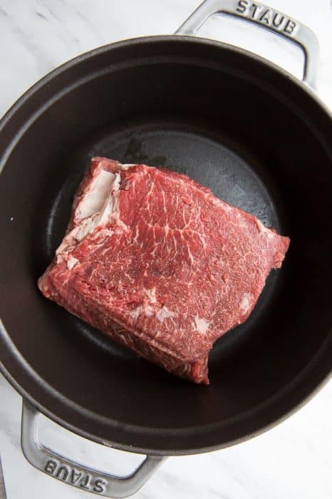 A Raw Cut of Beef in a Pan with Metal Handles