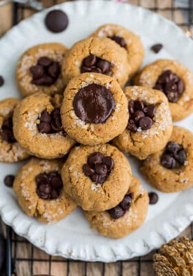 Top view of a full pile of keto peanut butter kiss cookies on a white plate