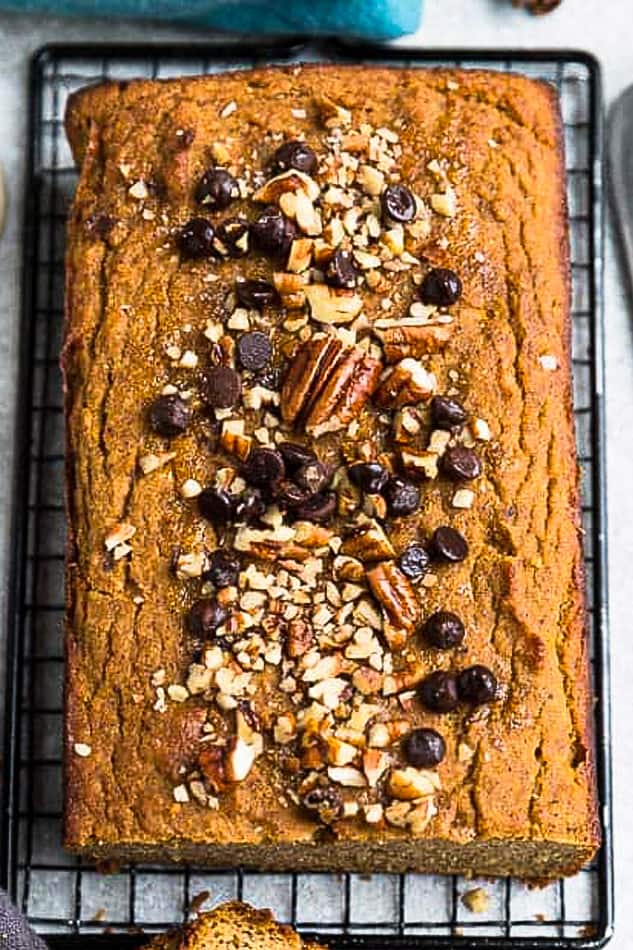 Close up top view of low carb paleo pumpkin bread with chocolate chips and pecans on a wire rack