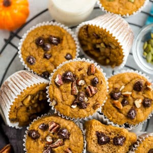 Top view of keto pumpkin muffins on a round wire rack on a grey background