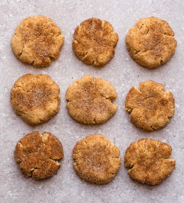 Top view of 9 keto snickerdoodles on a grey background