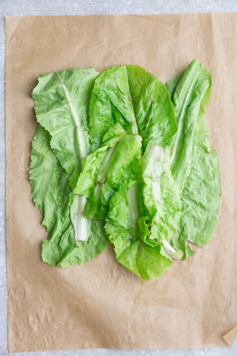 Top view of lettuce on a brown parchment paper to make low carb wraps