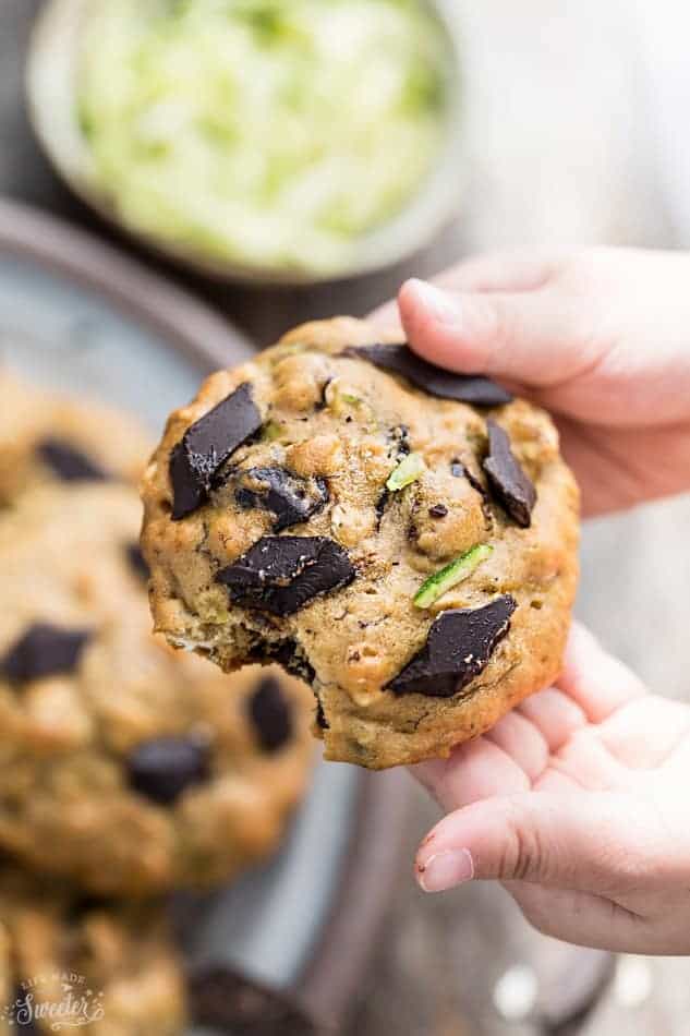 Close up view of hand holding one keto zucchini cookie