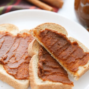 Side view of low carb pumpkin spread on toast on a white plate