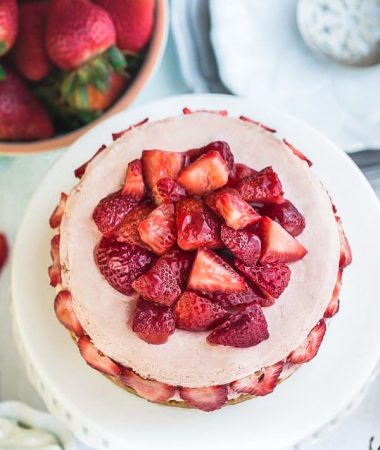 Top view of strawberry cheesecake with fresh strawberries.