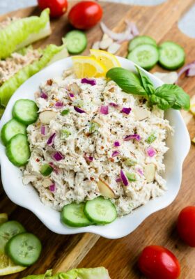 Top view of Whole30 classic chicken salad in a white bowl on a wooden board