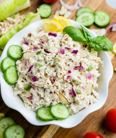 Top view of Whole30 classic chicken salad in a white bowl on a wooden board