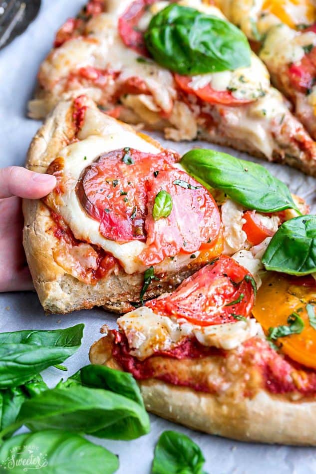 Margherita Pizza - a simple classic recipe that's made with Heirloom tomatoes, mozzarella and fresh basil. Easy and perfect for busy weeknights. Best of all, simple to customize with your favorite toppings