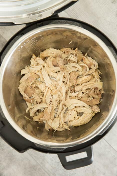 Overhead view of cooked shredded chicken in a mealthy multipot
