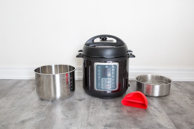 Mealthy Multipot with its cooking accessories next to it