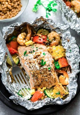 Top view of a Mediterranean Salmon Foil Packet with Lentils, shrimp and vegetables