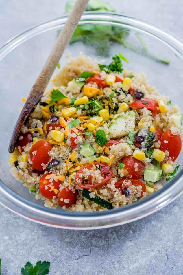 Mexican Quinoa Salad with delicious grilled corn and zucchini make the perfect summery meal. Best of all, it's so easy to customize and is loaded with cucumbers, black beans, cherry tomatoes,, red onions and optional shredded cheese and then tossed in a sweet and tangy honey lime vinaigrette.