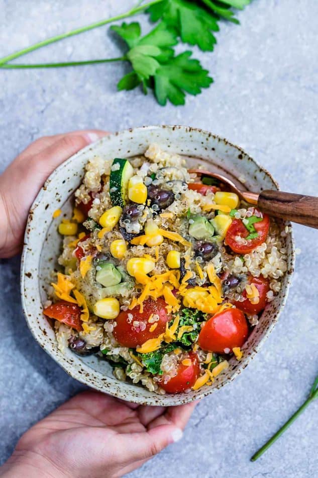 Mexican Quinoa Salad with delicious grilled corn and zucchini make the perfect summery meal. Best of all, it's so easy to customize and is loaded with cucumbers, black beans, cherry tomatoes,, red onions and optional shredded cheese and then tossed in a sweet and tangy honey lime vinaigrette.