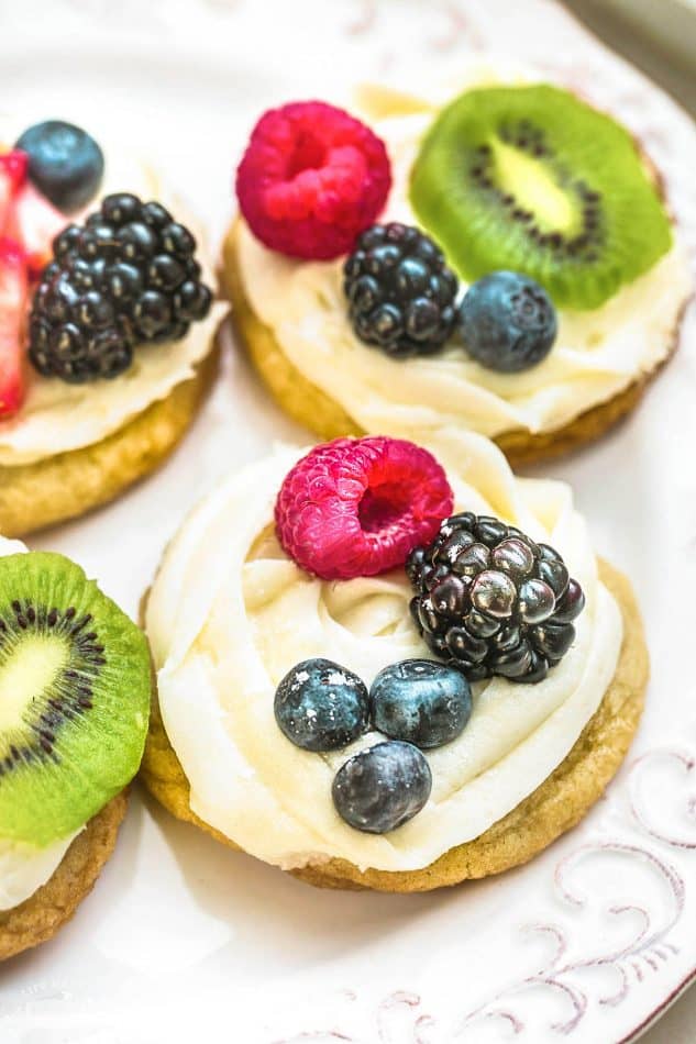 Mini Fruit Pizza - a classic dessert made using homemade soft sugar cookies topped with fresh fruit. Perfect for barbecues, potlucks and parties. Best of all, no dough chilling required and easy to customize!