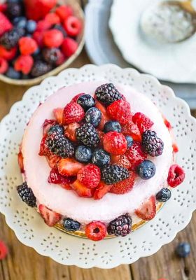 Top view of Keto Cheesecake decorated with mixed berries on a white plate
