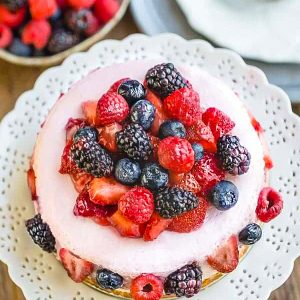 Low Carb Mixed Berry Cheesecake is rich, creamy and the perfect keto friendly dessert for spring and summer. Made with a gluten free almond flour crust, fresh pureed strawberries and a hint of lemon juice. A delicious no bake treat perfect for summer parties, barbecues, picnics and any special holiday. #summer #cheesecake #nobake #mixedberry #lowcarb #keto #cake #dessert #potluck #picnic #party