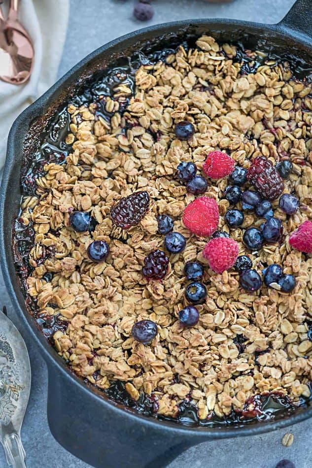 This delicious Mixed Berry Skillet Crisp is the perfect easy dessert to use up any summer or frozen berries. Best of all, there's only 10 minutes of prep time and is loaded with strawberries, blueberries, blackberries and raspberries. Plus, it's healthier than most crisps and crumbles since it's gluten-free, vegan and refined sugar free.