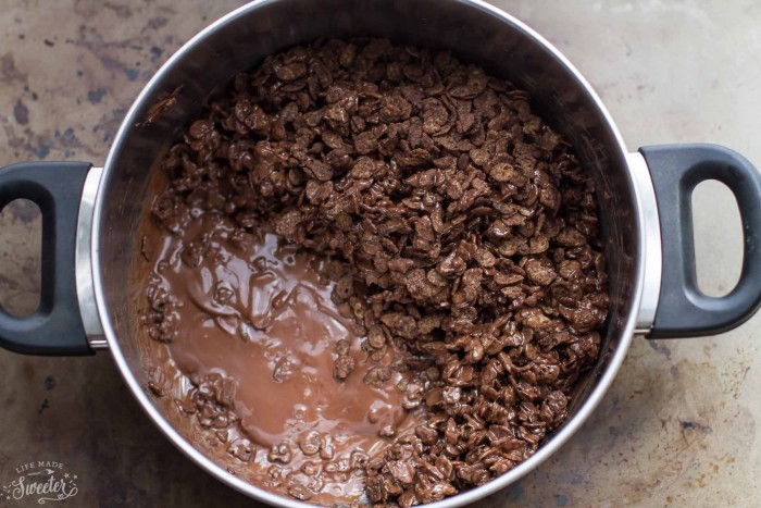 Chocolate ice cream cake recipe in the process of being cooked with melted chocolate and cereal. 